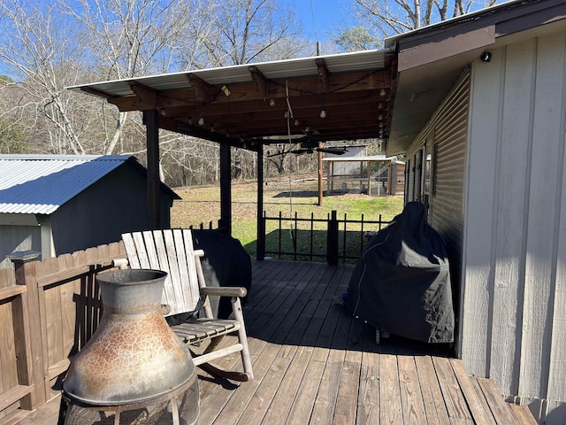 wooden deck with ceiling fan and a yard