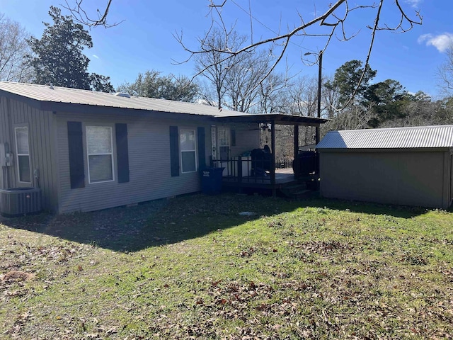 rear view of property featuring a lawn