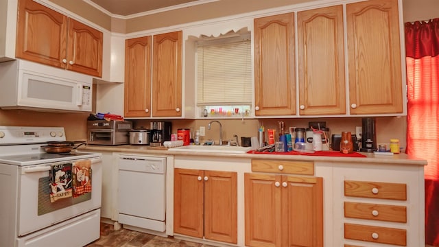 kitchen featuring light countertops, a sink, and white appliances