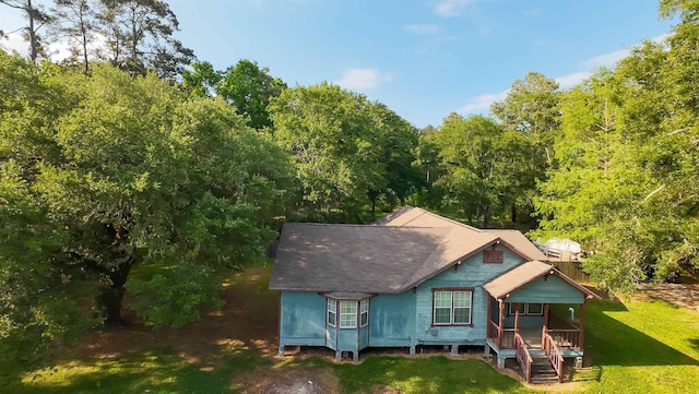 exterior space with a porch and a lawn