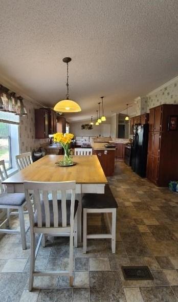 dining space featuring a textured ceiling