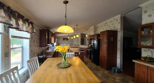 dining area with crown molding, plenty of natural light, and a textured ceiling