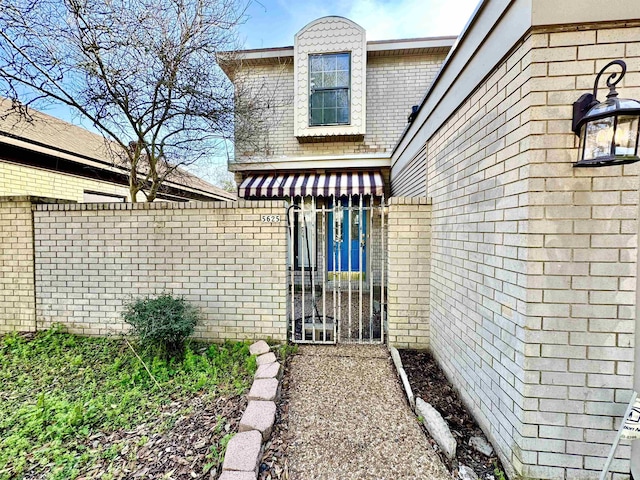 property entrance featuring brick siding