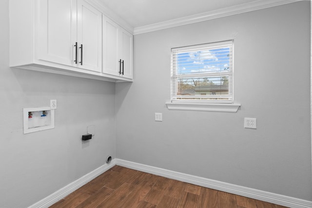 clothes washing area with dark wood-type flooring, cabinets, washer hookup, and crown molding