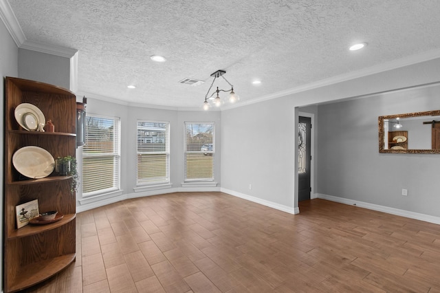 interior space with ornamental molding, wood-type flooring, and a textured ceiling