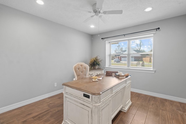 home office featuring a textured ceiling, dark wood-type flooring, and ceiling fan