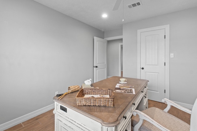 office area with ceiling fan and light hardwood / wood-style floors