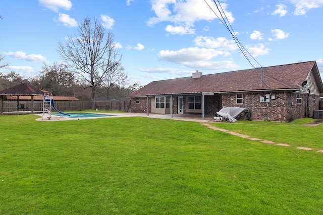 back of property featuring central AC, a gazebo, a lawn, a fenced in pool, and a patio