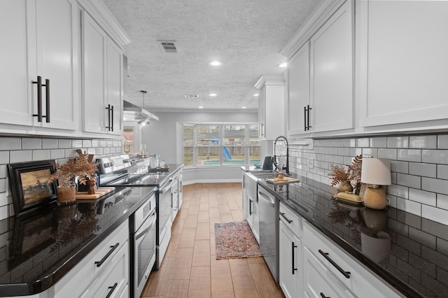 kitchen featuring stainless steel appliances, sink, and white cabinets