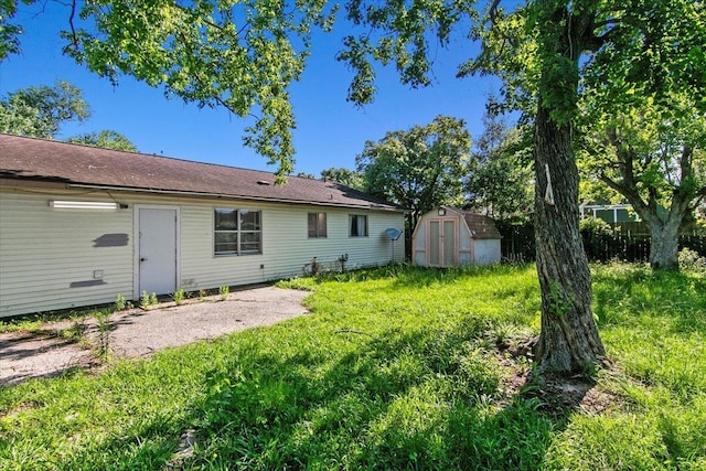 rear view of property with a patio and a shed