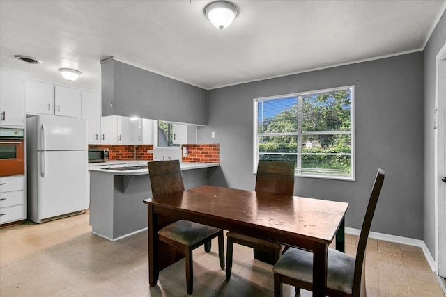 dining space featuring crown molding