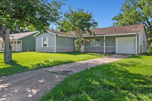 single story home featuring a front lawn and a garage