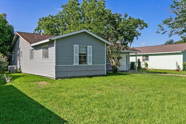 rear view of house with a lawn and cooling unit