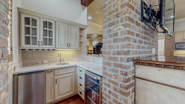 7705 Savannah St, Beaumont, TX 77707 - kitchen featuring fridge, beverage cooler, ornamental molding, stainless steel microwave, and cream cabinets