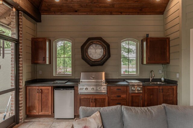 7705 Savannah St, Beaumont, TX 77707 - kitchen with refrigerator, a sink, vaulted ceiling, wooden ceiling, and dark countertops