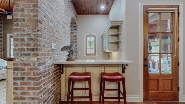 7705 Savannah St, Beaumont, TX 77707 - indoor wet bar featuring wood ceiling and brick wall