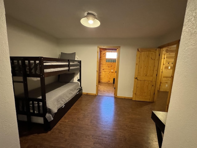 bedroom with dark wood-type flooring and ensuite bath