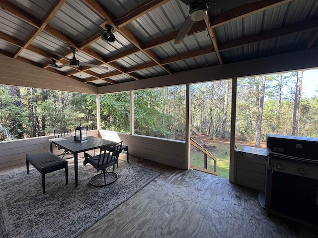 sunroom / solarium with lofted ceiling, ceiling fan, and a healthy amount of sunlight