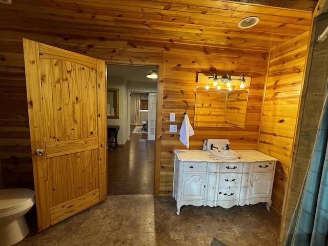 bathroom with toilet and wood ceiling