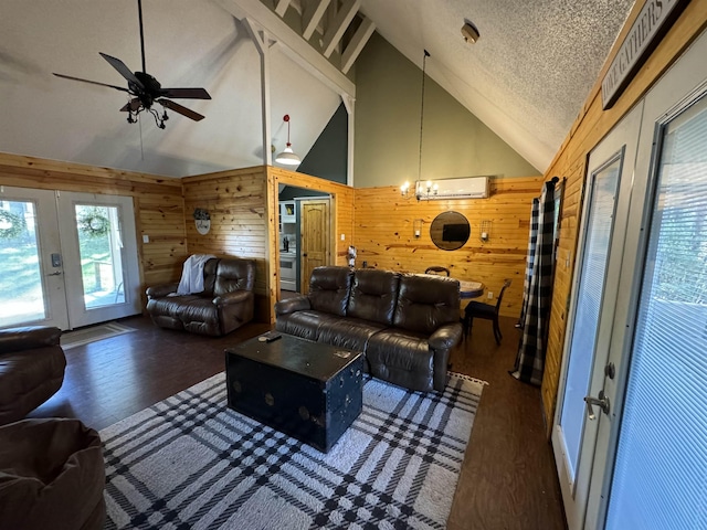 living room featuring a wall mounted AC, french doors, wood walls, dark hardwood / wood-style floors, and high vaulted ceiling