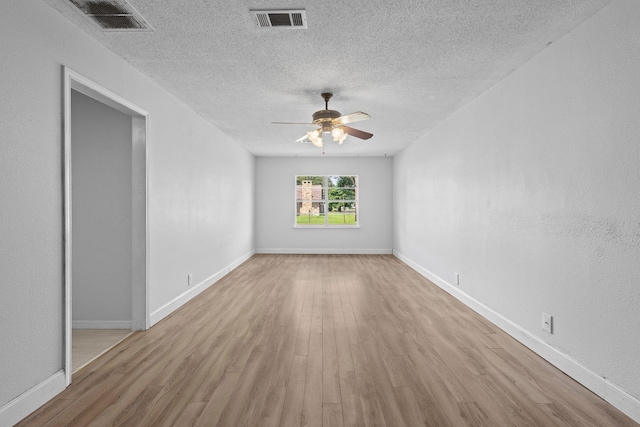 305 White Oak Trl, Bridge City, TX 77611 - spare room with a ceiling fan, wood finished floors, a textured ceiling, and baseboards