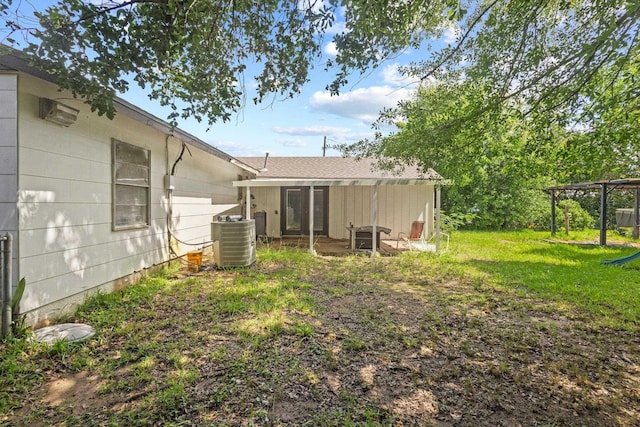 305 White Oak Trl, Bridge City, TX 77611 - back of property with cooling unit and a lawn