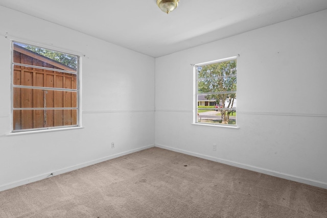 305 White Oak Trl, Bridge City, TX 77611 - carpeted empty room with baseboards and healthy amount of natural light