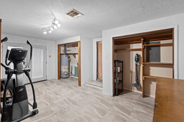 305 White Oak Trl, Bridge City, TX 77611 - exercise room featuring gas water heater, electric panel, a textured ceiling, and baseboards