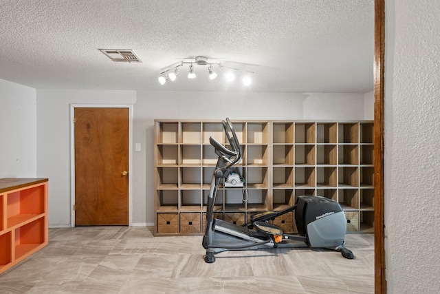305 White Oak Trl, Bridge City, TX 77611 - workout room featuring a textured ceiling