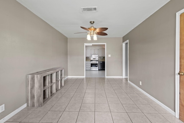305 White Oak Trl, Bridge City, TX 77611 - empty room with a ceiling fan, light tile patterned floors, and baseboards