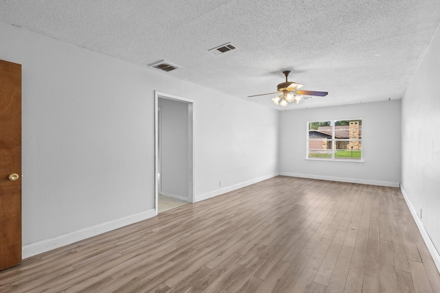 305 White Oak Trl, Bridge City, TX 77611 - spare room featuring wood finished floors, a ceiling fan, a textured ceiling, and baseboards
