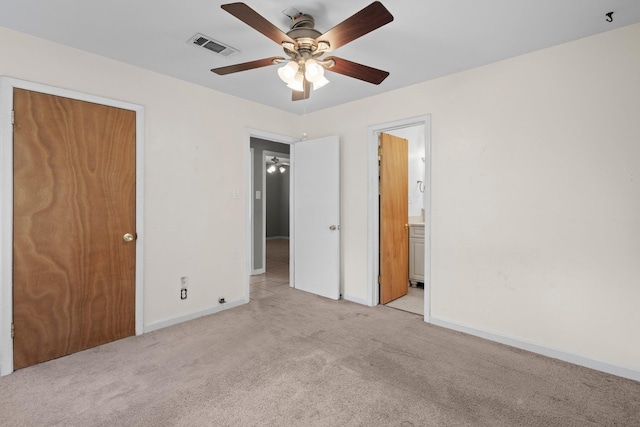 305 White Oak Trl, Bridge City, TX 77611 - unfurnished bedroom featuring light colored carpet, baseboards, ceiling fan, and ensuite bath