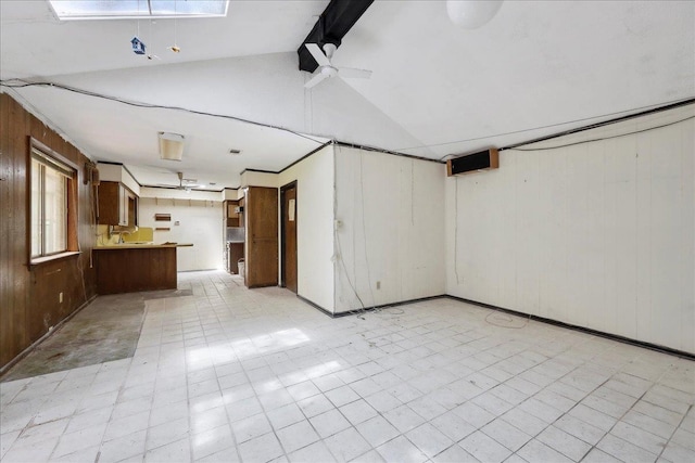 basement featuring wood walls and light floors