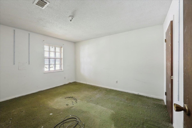 empty room with baseboards, visible vents, and carpet floors