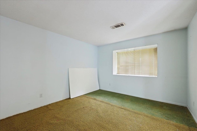 carpeted empty room with visible vents