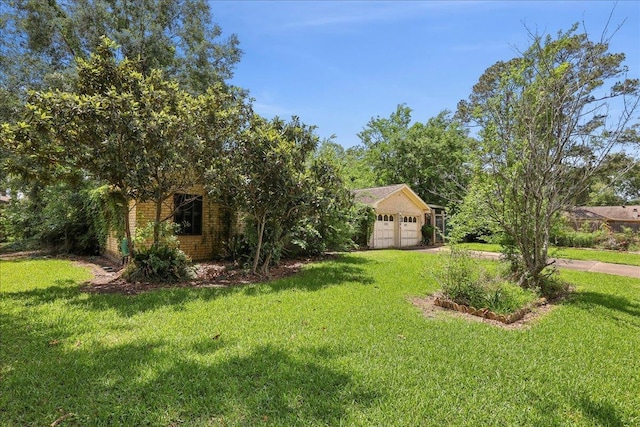 view of yard with driveway and a garage