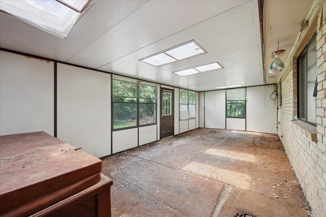 unfurnished sunroom with a skylight and a jacuzzi