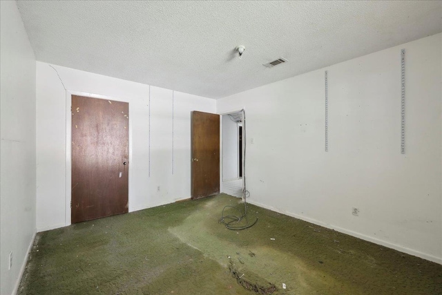 unfurnished room featuring visible vents