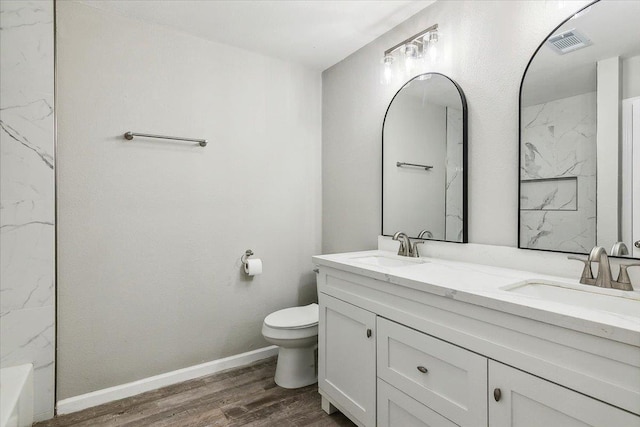 bathroom featuring vanity, wood-type flooring, and toilet