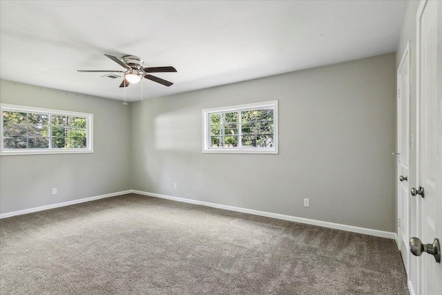 spare room with carpet flooring, ceiling fan, and a healthy amount of sunlight