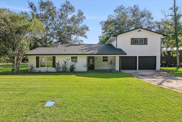 view of front facade with a garage and a front lawn