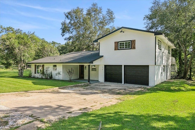 view of front of property featuring a garage and a front lawn