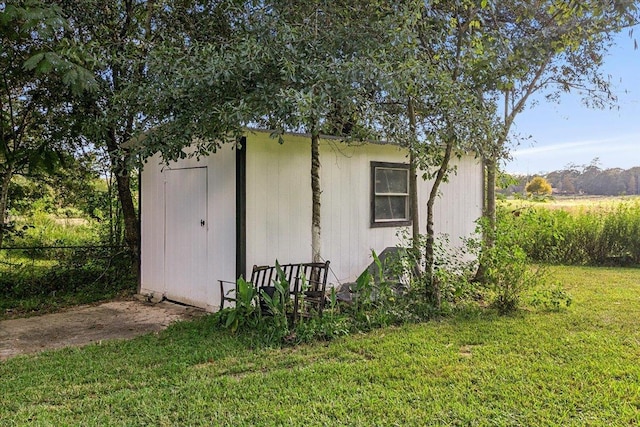 view of outbuilding featuring a yard