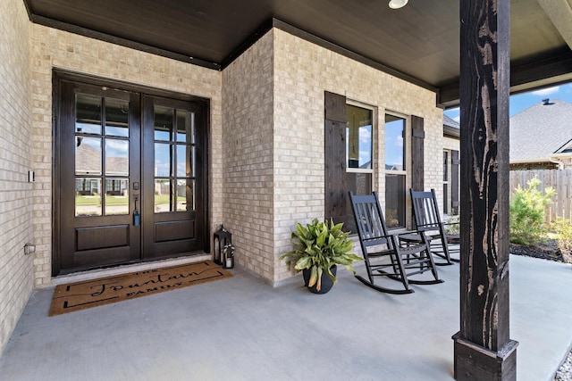 entrance to property with covered porch and french doors