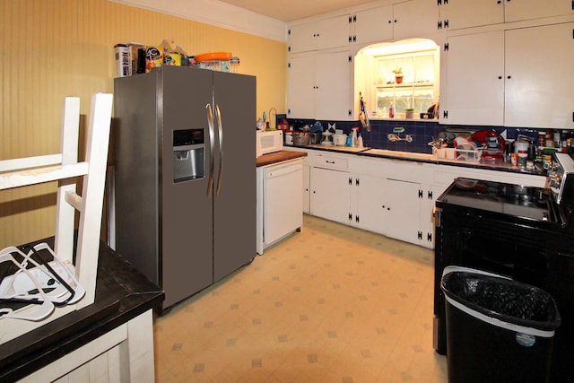 kitchen with light floors, backsplash, white cabinetry, and white appliances