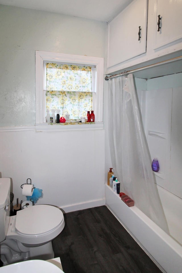 full bathroom with shower / tub combo, toilet, and wood finished floors