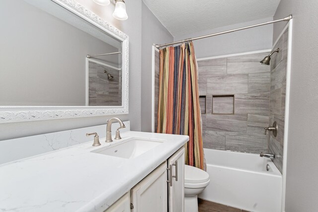 314 Pinehurst Dr, Sour Lake, TX 77659 - bathroom with toilet, shower / bath combo with shower curtain, a textured ceiling, vanity, and wood finished floors