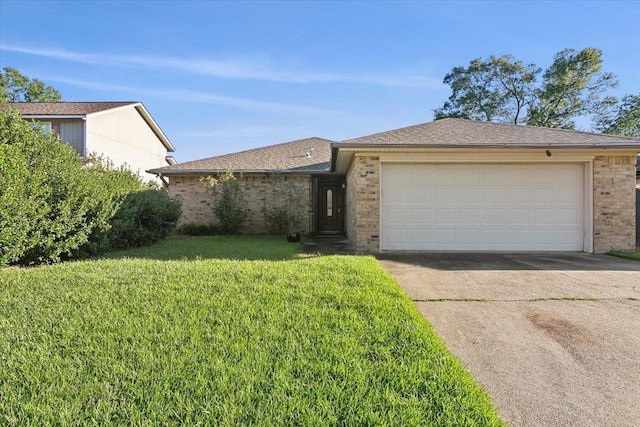 ranch-style house featuring a garage and a front lawn