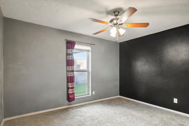 empty room featuring carpet, ceiling fan, and a textured ceiling