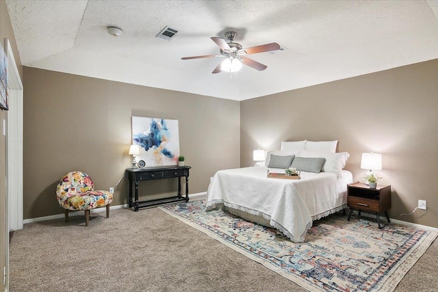 bedroom featuring carpet, ceiling fan, and a textured ceiling